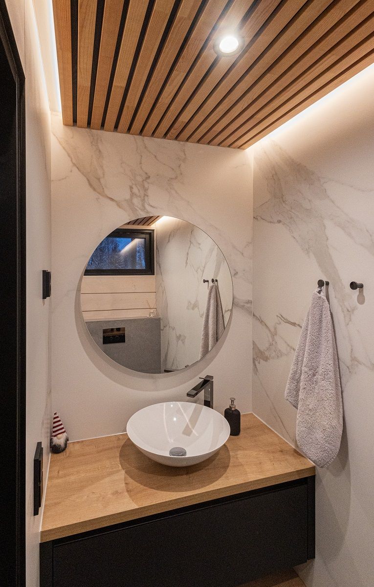 Indirect LED strip lighting in a small toilet reflects beautifully through glossy walls. With additional 9 watt spotlight